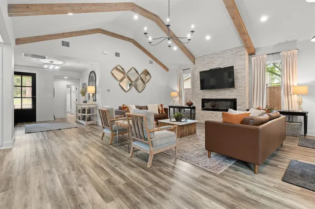 a living room with furniture kitchen view and a table