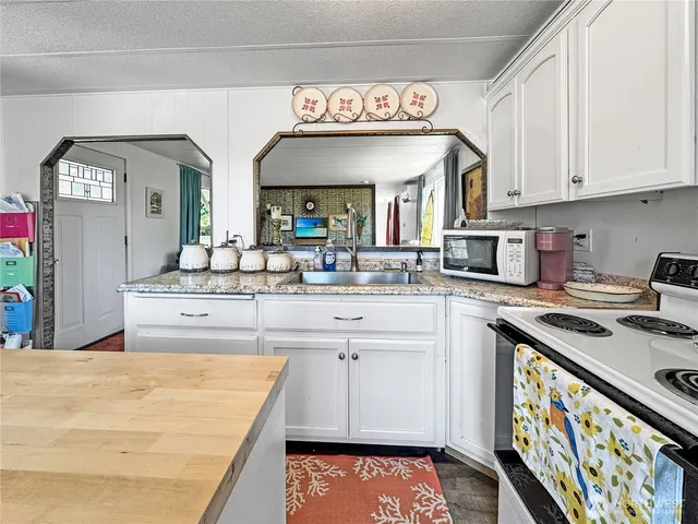 a kitchen with stainless steel appliances granite countertop a stove and cabinets
