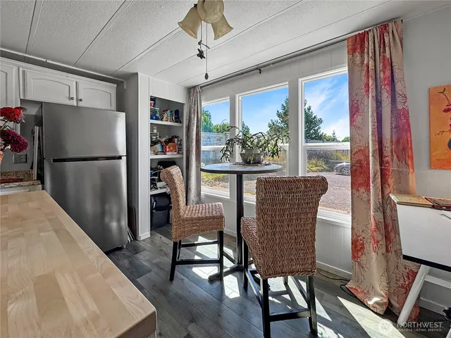 a dining room with furniture a chandelier and wooden floor