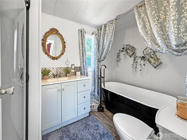 a bathroom with a toilet a sink and a mirror