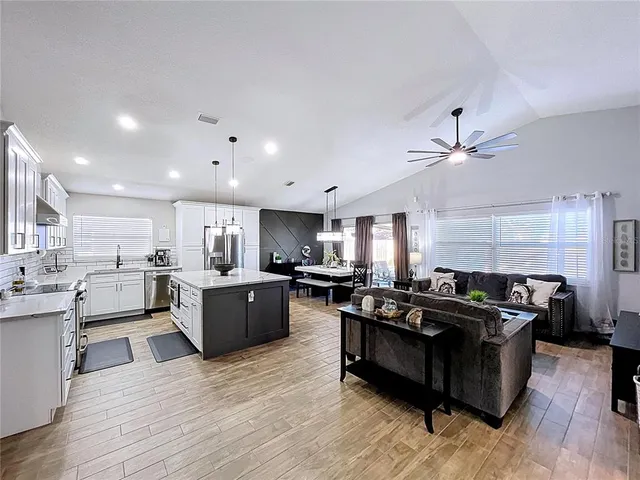 a large kitchen with a dining table and chairs