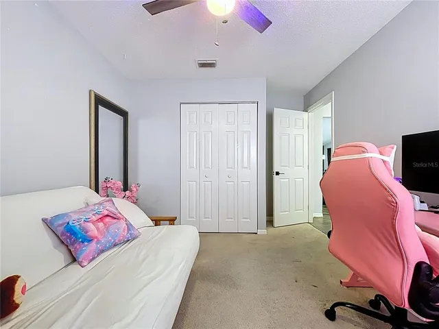 a front view of a house with a yard garage and a tree