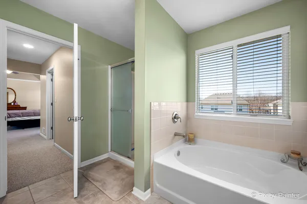 a bedroom with a bed and a ceiling fan