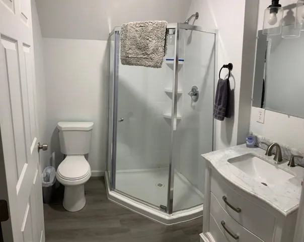 a bathroom with a toilet sink and a shower