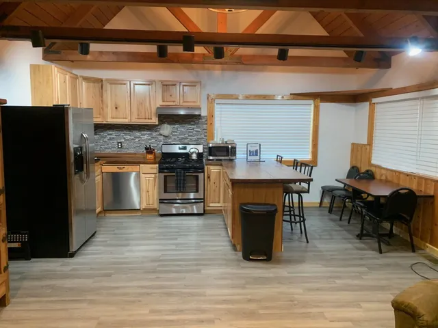 a kitchen with stainless steel appliances granite countertop a stove and a refrigerator