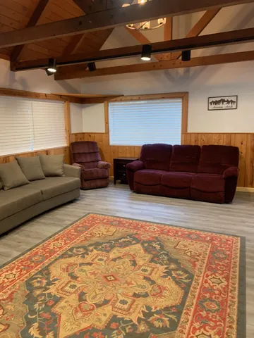 a living room with furniture and a rug
