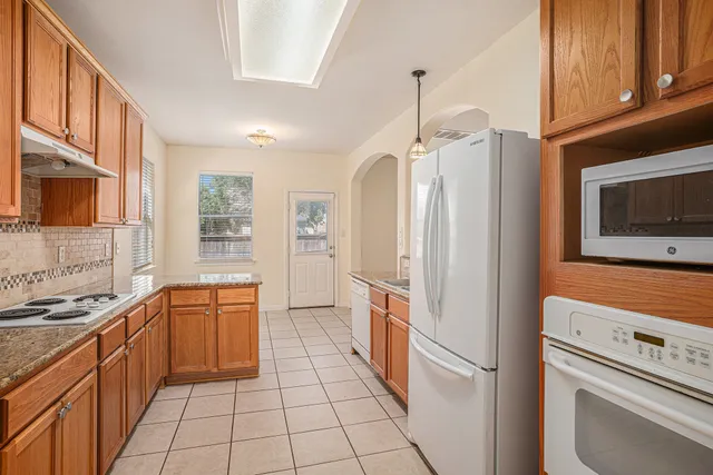 a kitchen with stainless steel appliances a refrigerator sink and cabinets