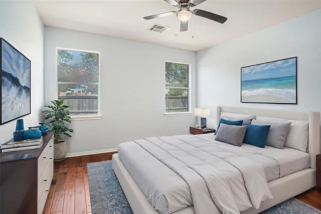 a bedroom with a large bed and a chandelier