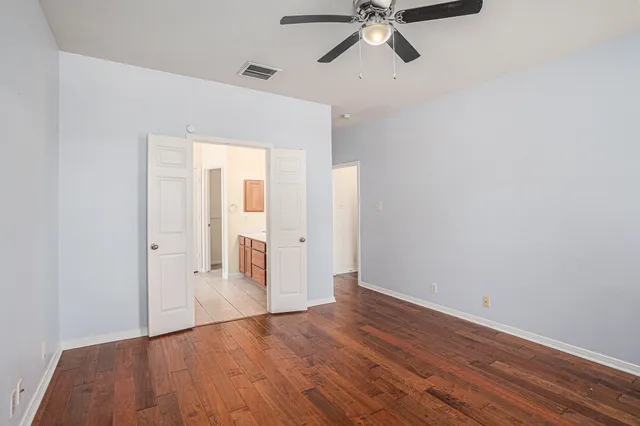 a view of a room with wooden floor and white walls