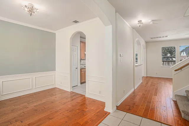 a view of a bedroom with wooden floor and cabinet