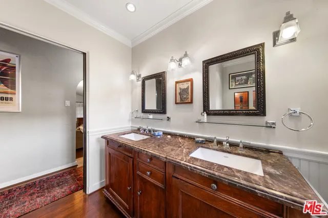 a spacious bedroom with a bed and a flat screen television