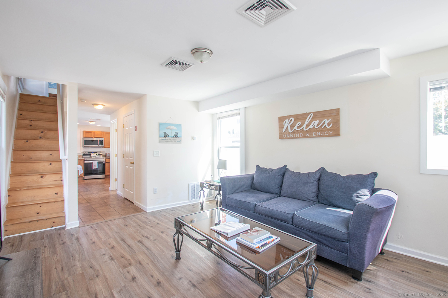 85 Melba Street, Unit 1 Milford, CT 06460 - Photo 2 of 14 a living room with furniture and a wooden floor