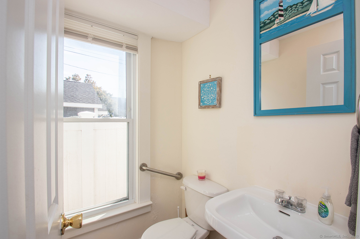 85 Melba Street, Unit 1 Milford, CT 06460 - Photo 6 of 14 a bathroom with a sink and a mirror