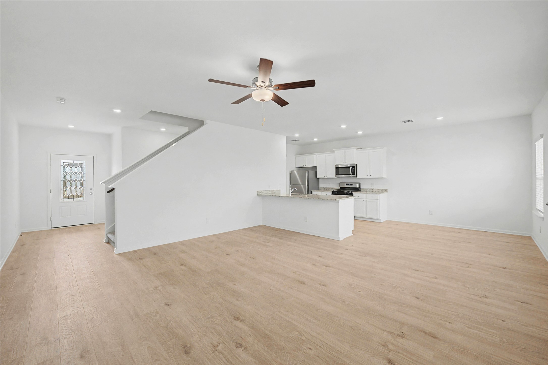 237 Fairlawn Way Maxwell, TX 78656 - Photo 2 of 13 Open-concept living area featuring wood-finish flooring, recessed lighting, and a ceiling fan