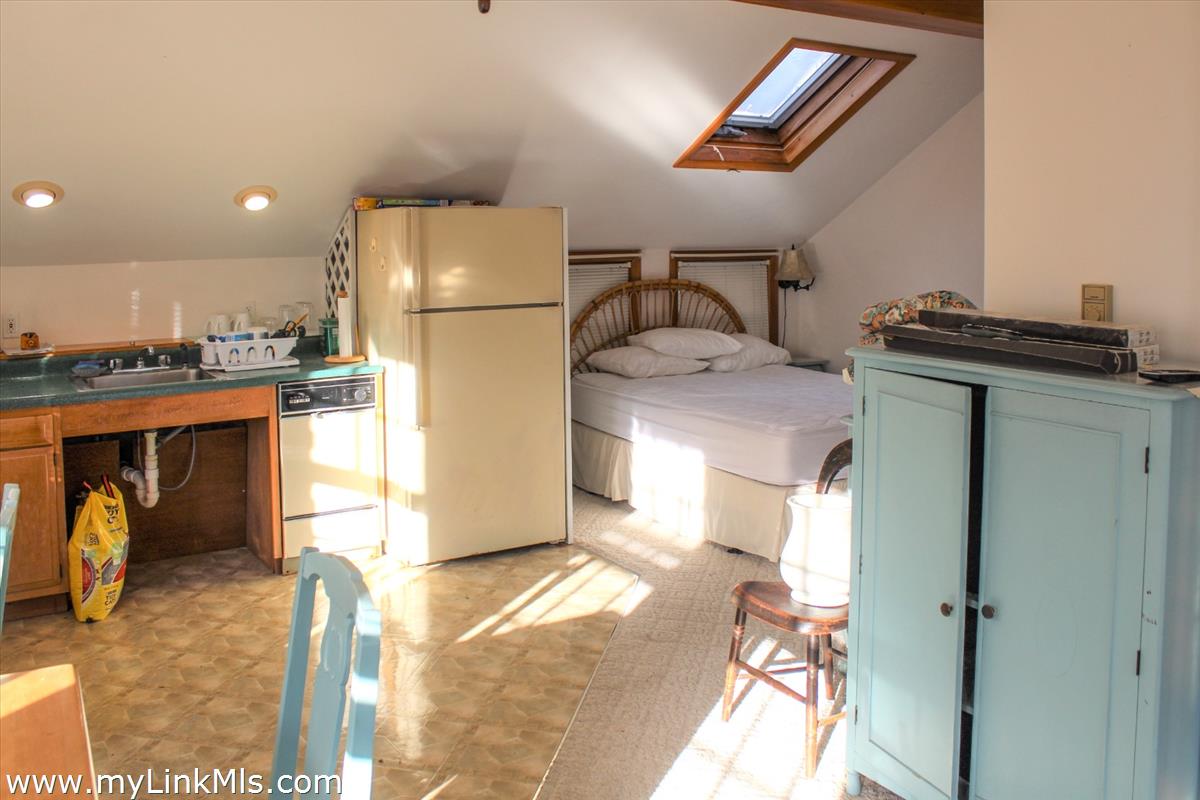 8 Sea Street Nantucket, MA 02554 - Photo 4 of 7 a kitchen with stainless steel appliances granite countertop a refrigerator and a stove
