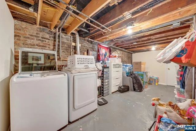 a view of storage and utility room with dryer and washer