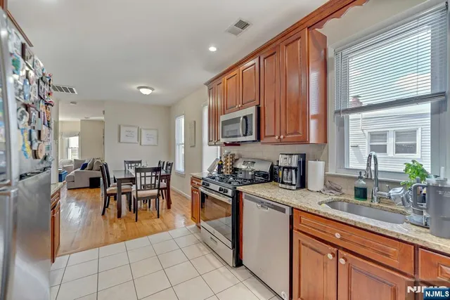 a kitchen with stainless steel appliances granite countertop sink stove and cabinets