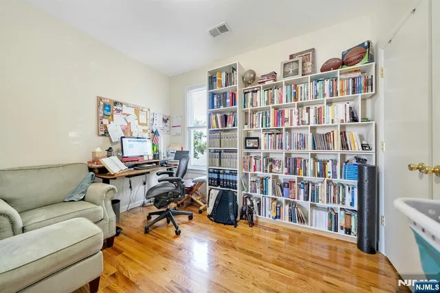 a living room with furniture and a book shelf