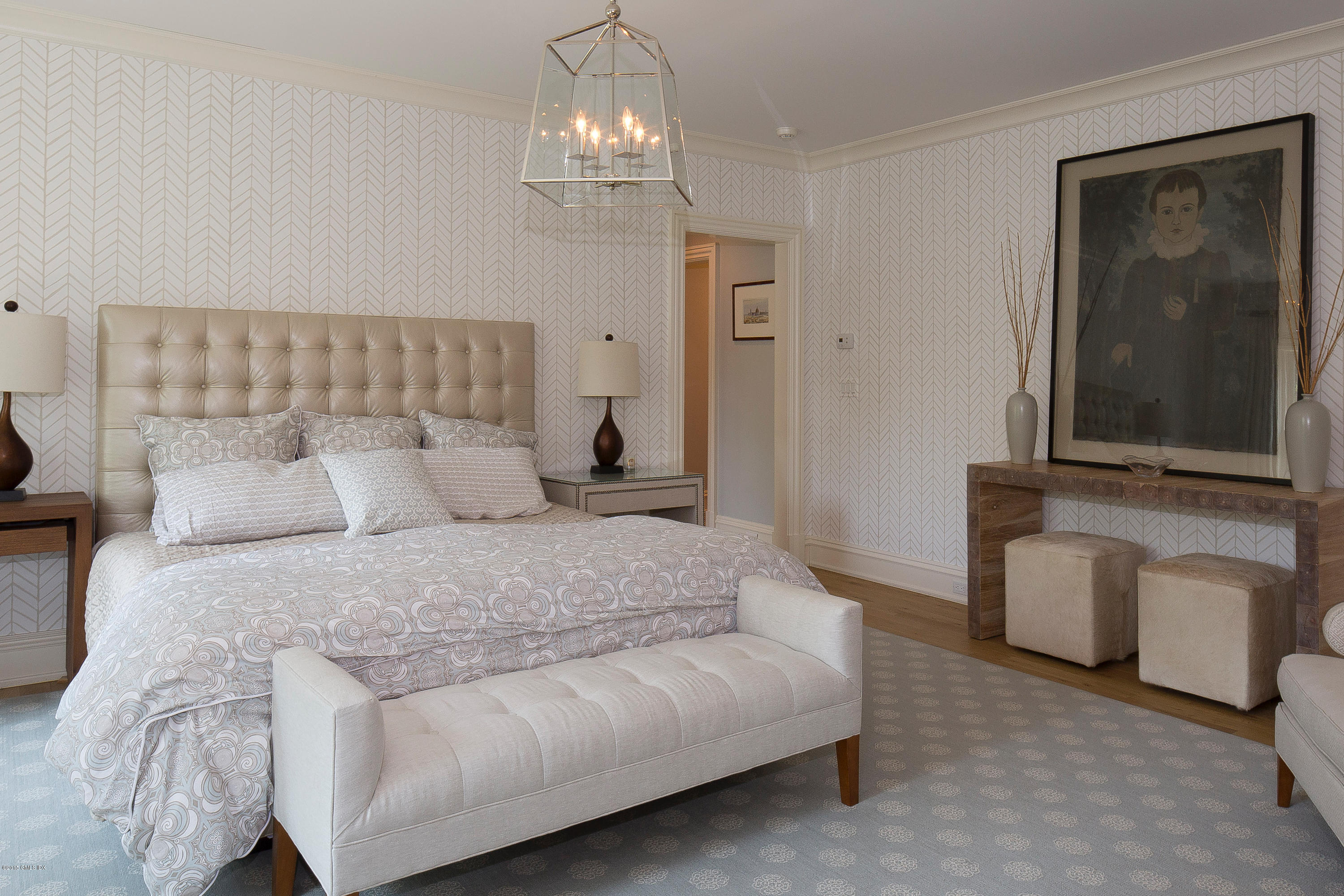 264 Riverside Avenue Riverside, CT 06878 - Photo 15 of 27 a spacious bedroom with a bed and a chandelier