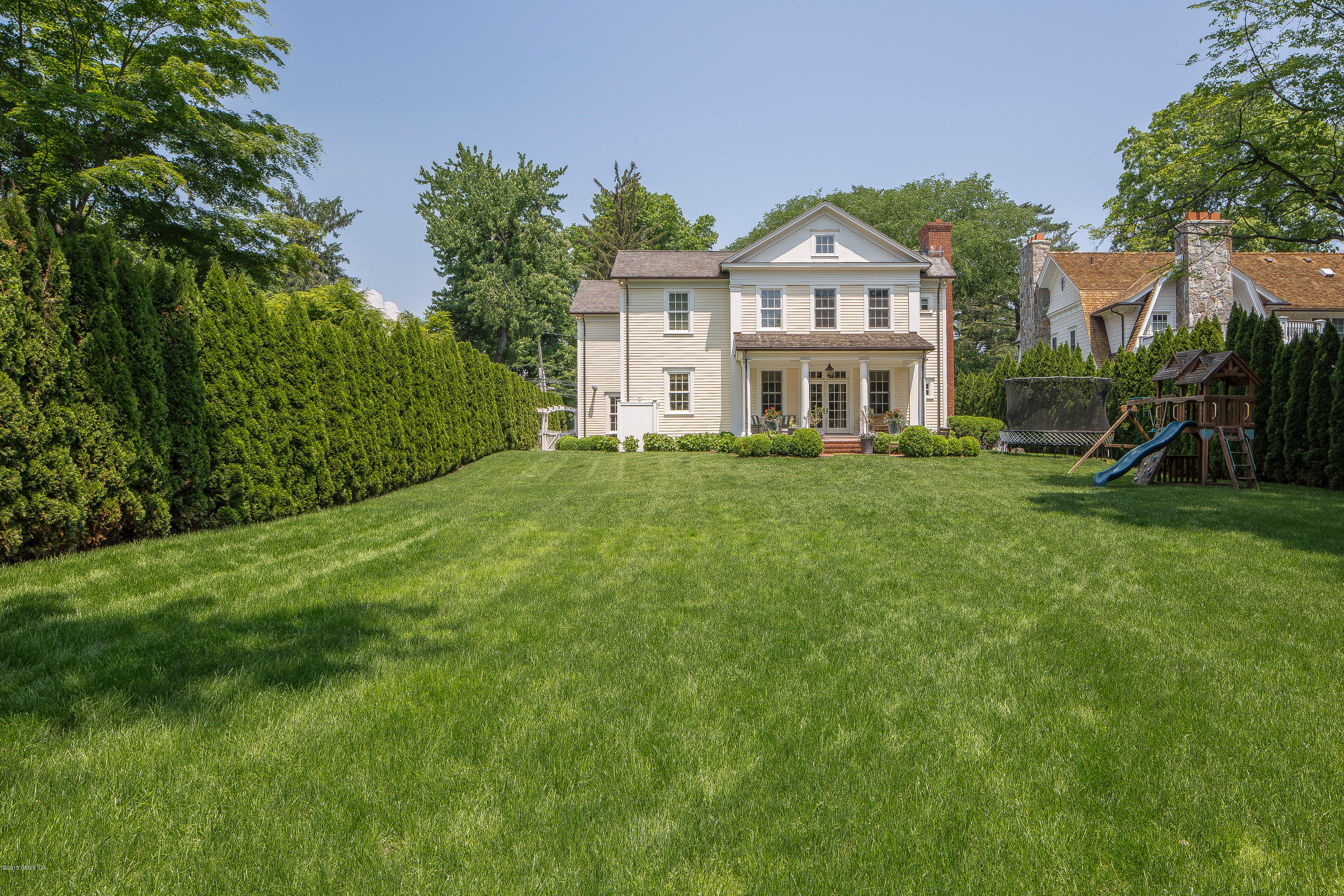 264 Riverside Avenue Riverside, CT 06878 - Photo 23 of 27 a front view of a house with a garden