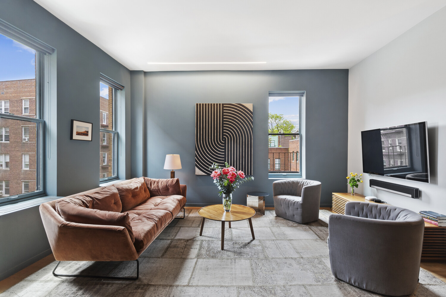 10 Bethune Street, Unit 4A Manhattan, NY 10014 - Photo 2 of 8 a living room with furniture and a flat screen tv