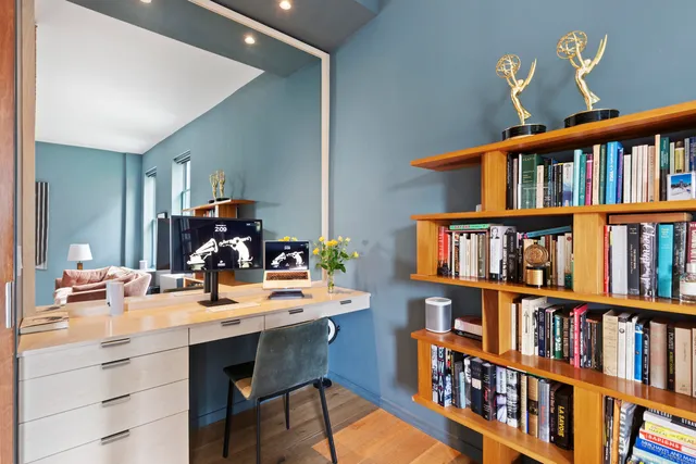 a workspace with a book shelf and a book shelf
