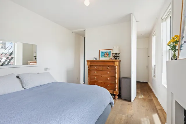 a bedroom with a bed and a dresser