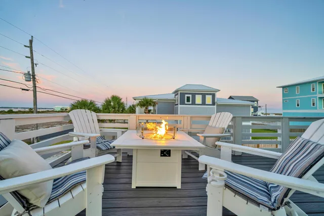 a view of a balcony with two chairs and a table