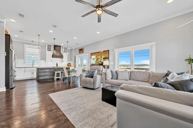 a living room with furniture and kitchen view