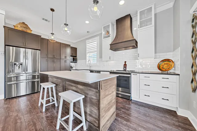 a kitchen with a stove a refrigerator and a sink
