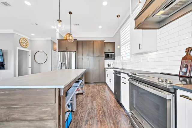 a kitchen with a stove a sink and a refrigerator