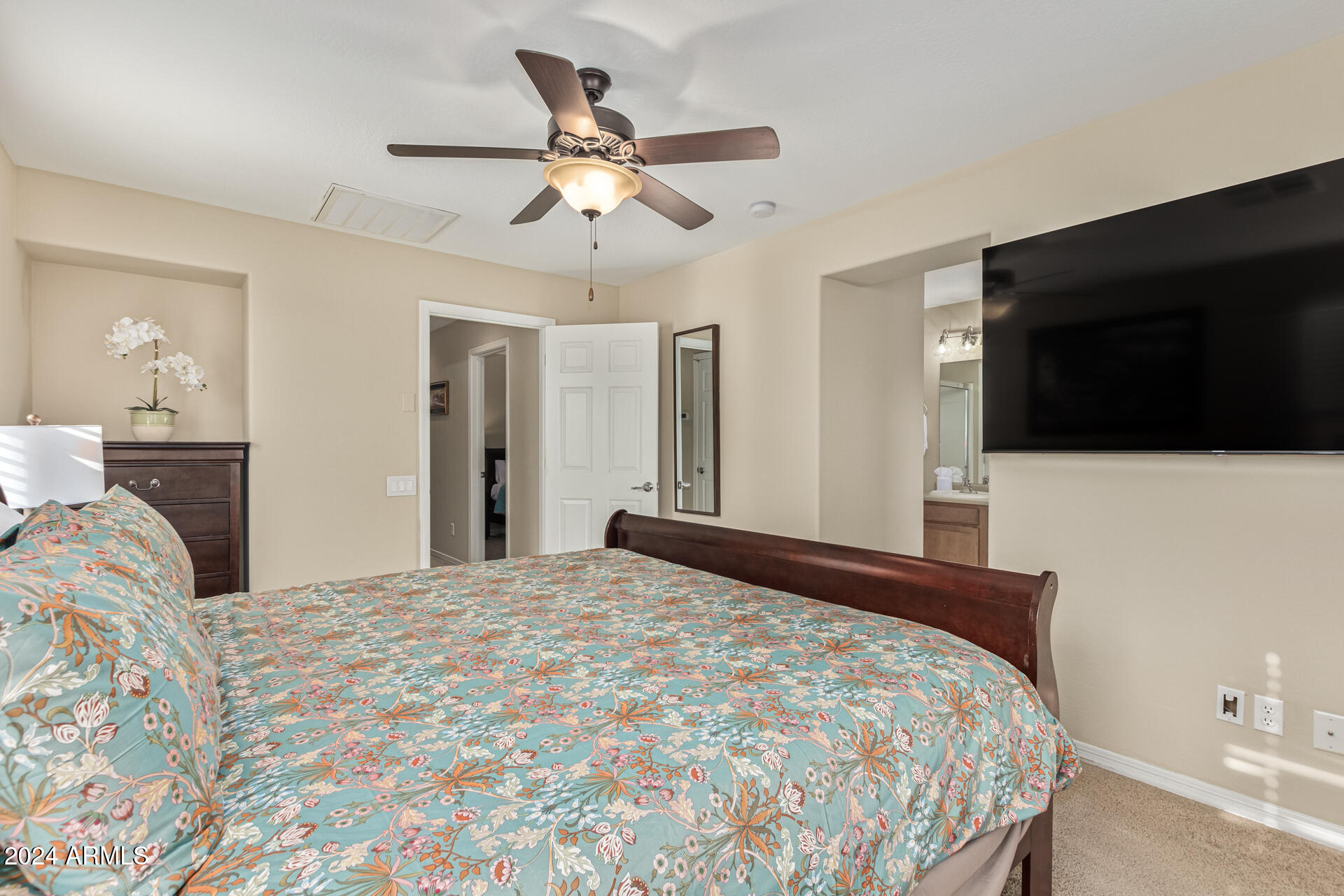 2179 Scully Drive Phoenix, AZ 85023 - Photo 18 of 32 a bedroom with a bed and a flat tv screen on dresser