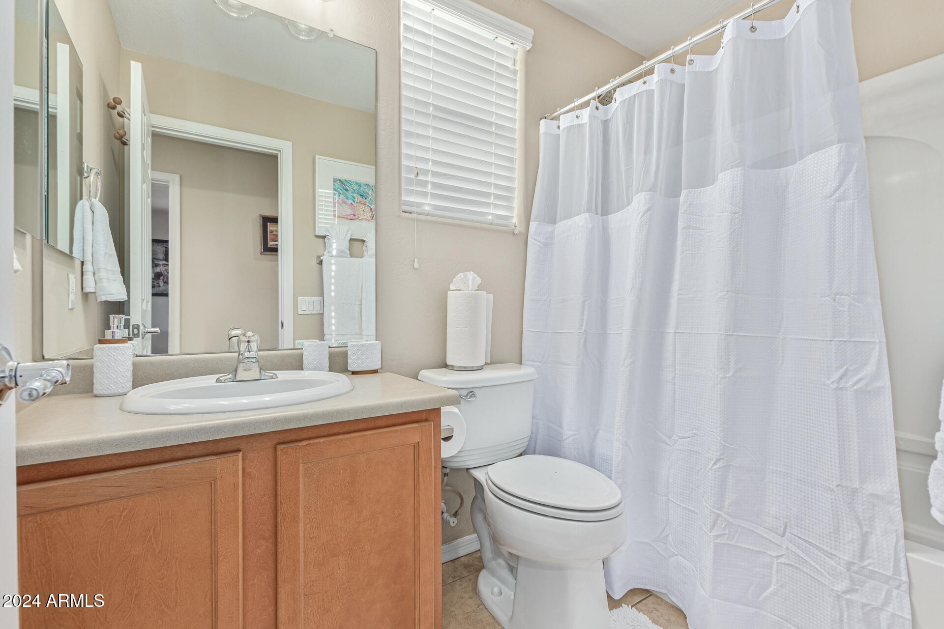 2179 Scully Drive Phoenix, AZ 85023 - Photo 22 of 32 a bathroom with a sink a toilet and shower curtain