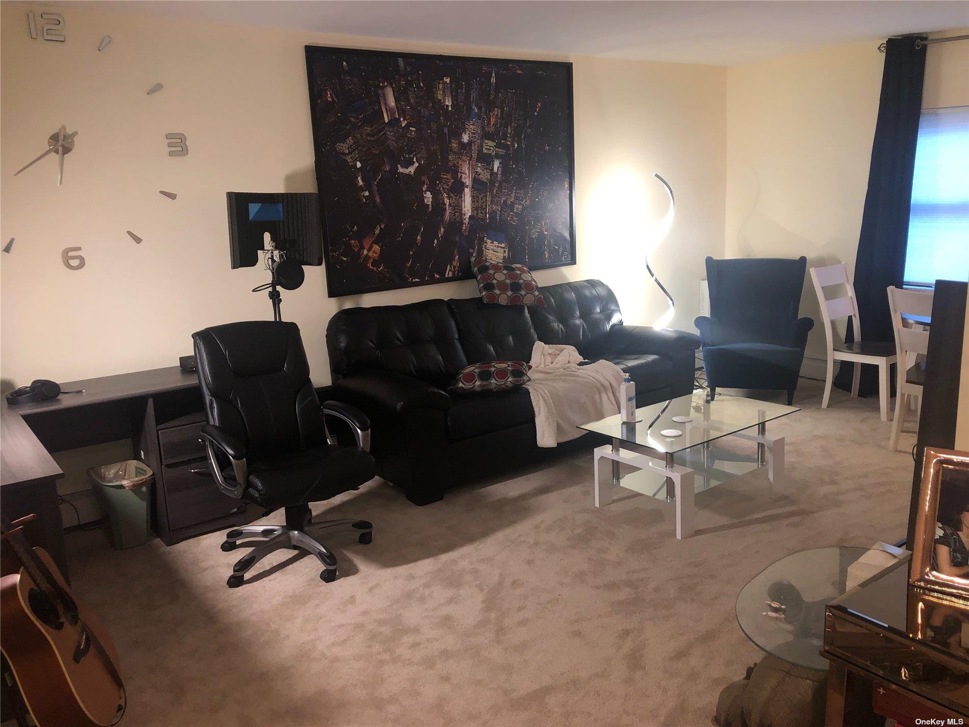 55 Tulip Avenue, Unit 63 Floral Park, NY 11001 - Photo 1 of 7 a living room with furniture and wooden floor