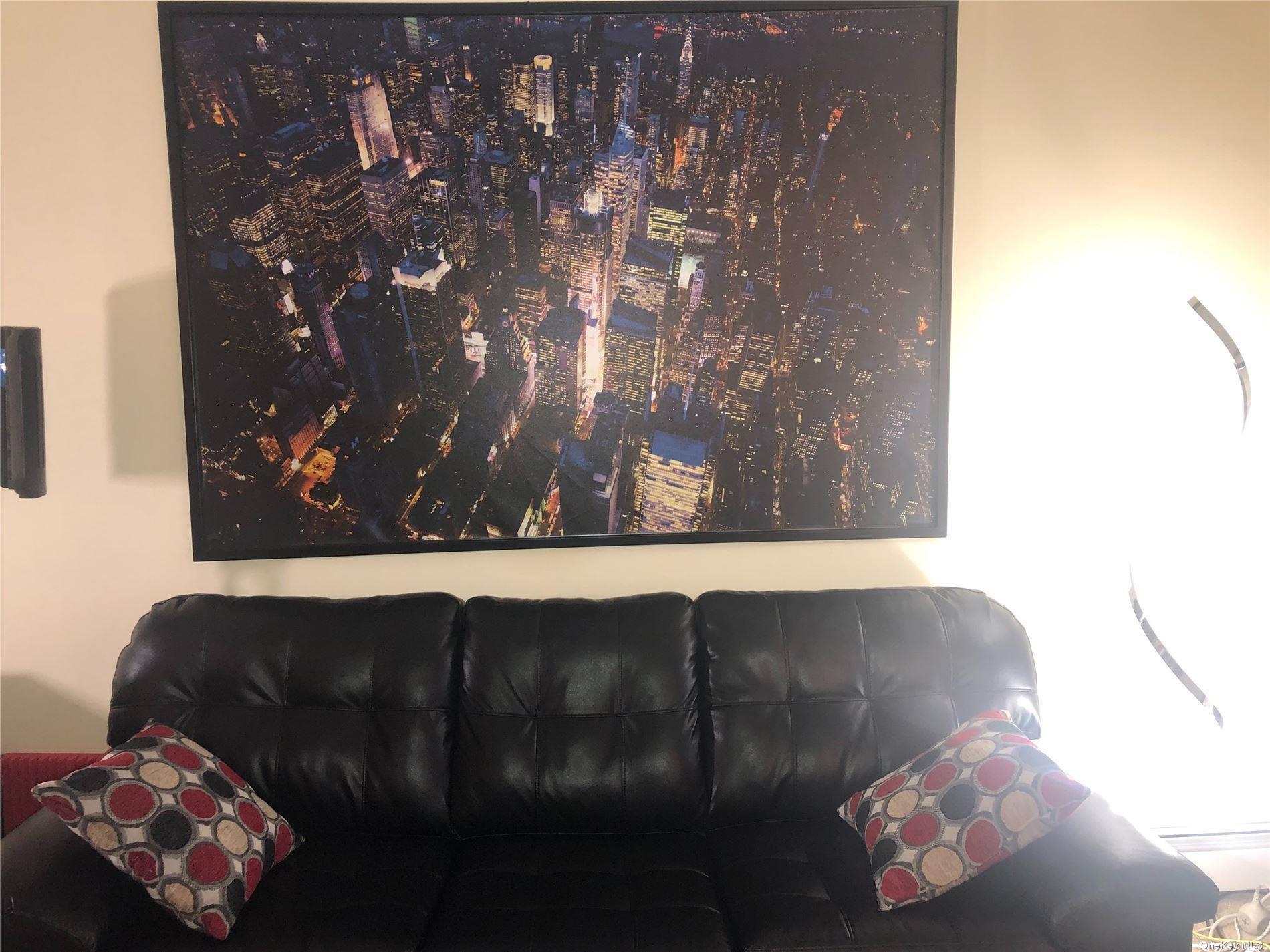 55 Tulip Avenue, Unit 63 Floral Park, NY 11001 - Photo 2 of 7 a living room with a couch