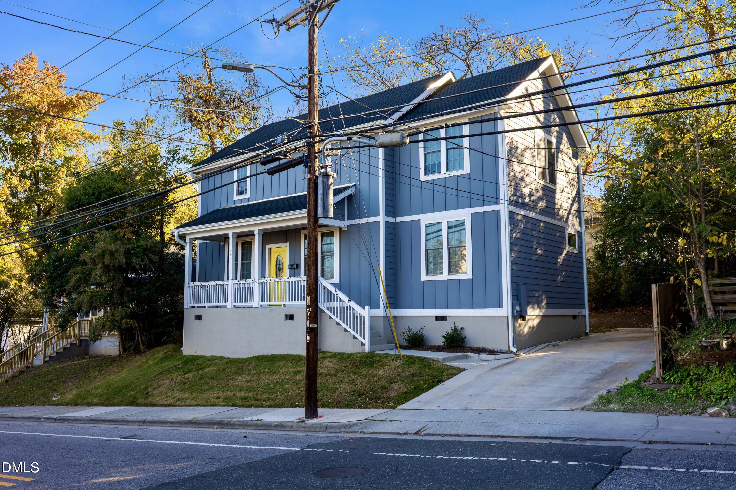 1521 Chapel Hill Road Durham, NC 27701 - Photo 1 of 42 a view of a white house with a yard and plants