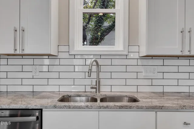 a kitchen with granite countertop a sink and a window