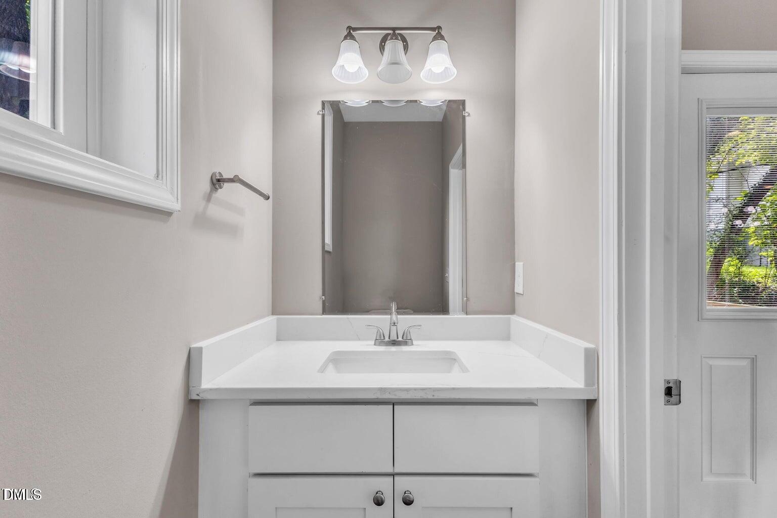 1521 Chapel Hill Road Durham, NC 27701 - Photo 17 of 42 a bathroom with a granite countertop sink and a mirror