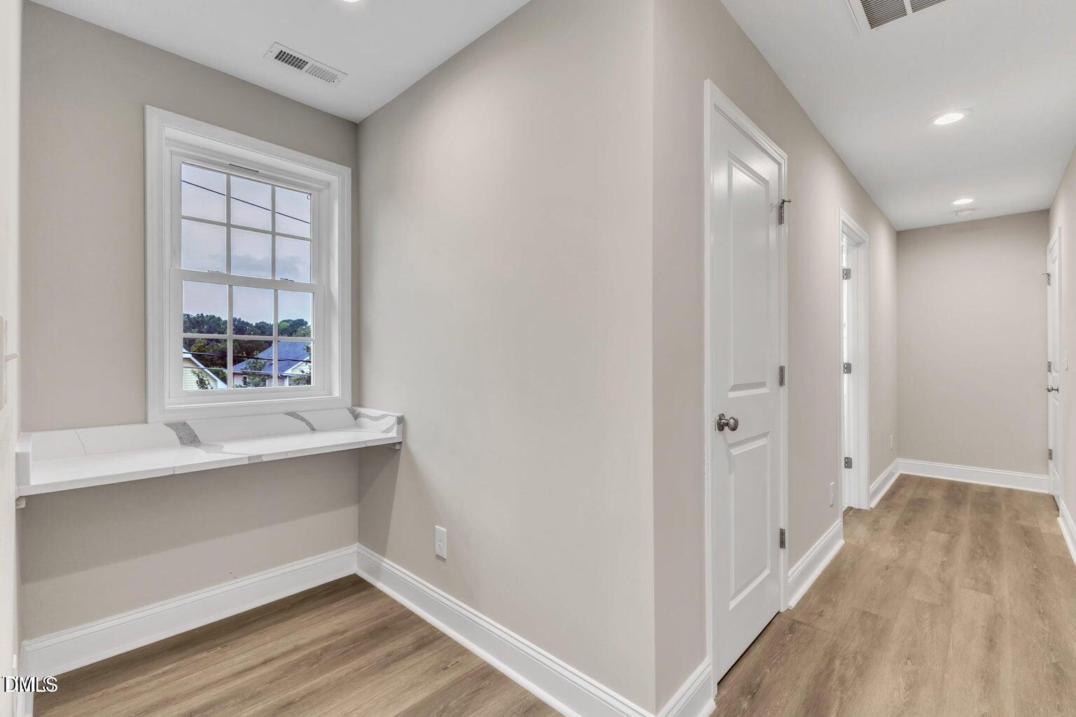1521 Chapel Hill Road Durham, NC 27701 - Photo 25 of 42 a view of an empty room with wooden floor and a window
