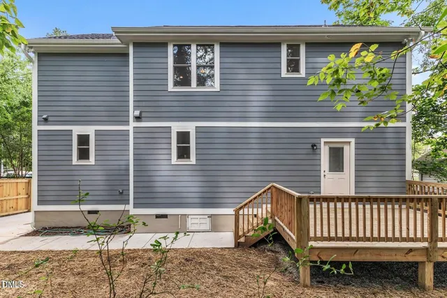 a view of a house with a window and wooden fence