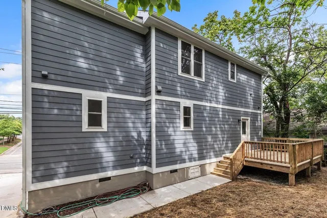 a side view of a house with a yard