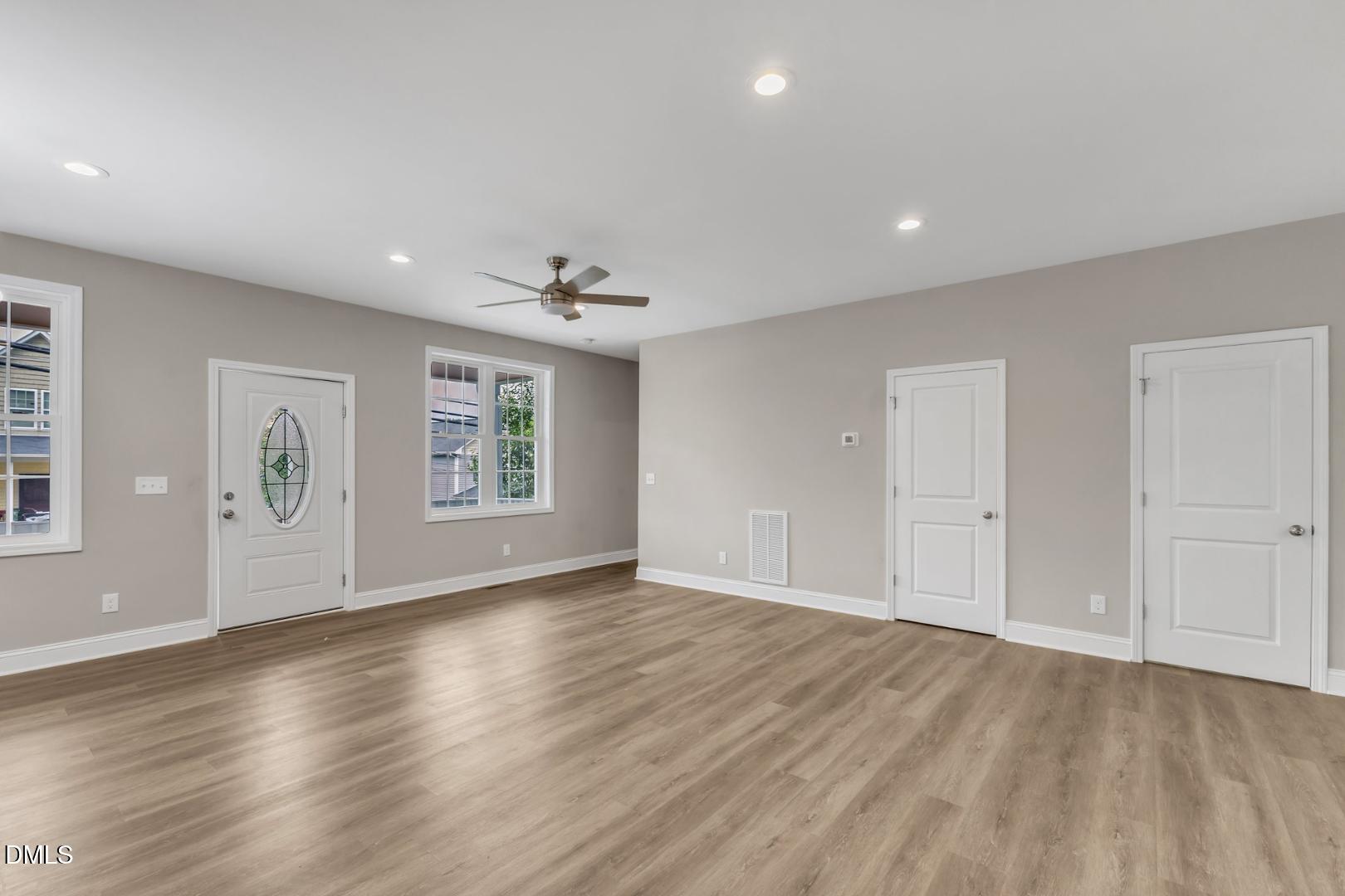 1521 Chapel Hill Road Durham, NC 27701 - Photo 7 of 42 a view of an empty room with wooden floor and a window