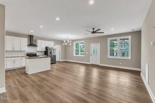 a view of kitchen with granite countertop stainless steel appliances cabinets and a window