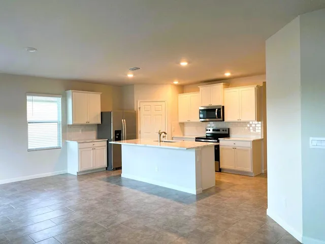 a kitchen with a sink and stainless steel appliances
