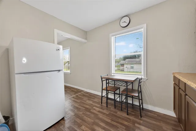 a view of dining room with furniture and a refrigerator