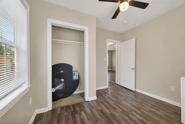 a view of an empty room and wooden floor