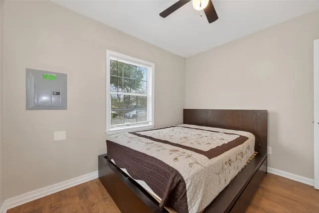 a bed sitting in a bedroom next to a window