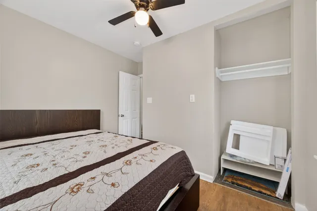 a bedroom with a bed and a flat tv screen on dresser