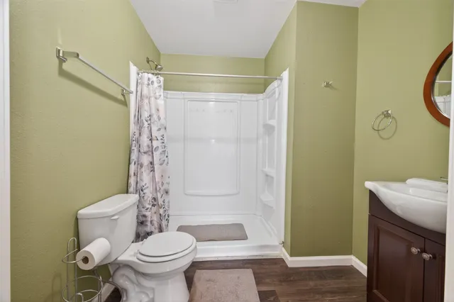 a bathroom with a toilet and a shower