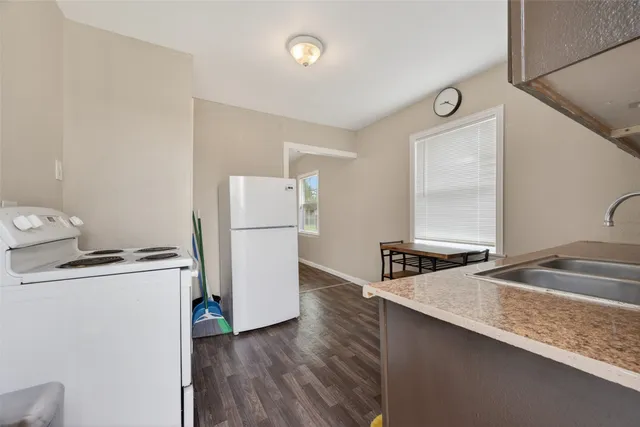 a kitchen with a refrigerator and a sink